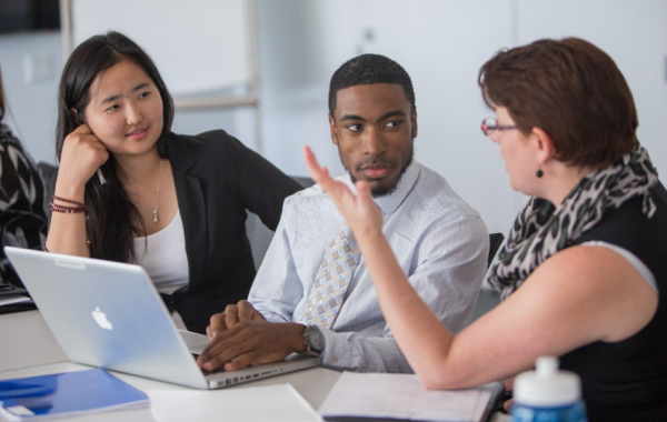 Internships allow you to examine career paths while gaining professional experience that boosts your post-college prospects. interns at work
