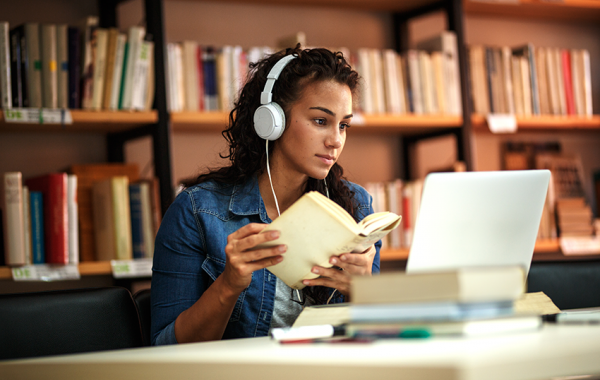 Top 5 Skills Every Young Professional Should Have (and the Books that Teach Them) Young lady reading a book with headphones one