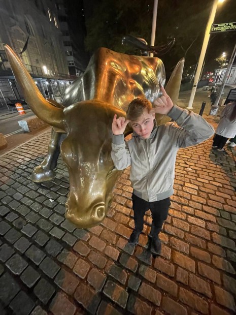 Vic Winderix with the bull on Wall Street in New York City, New York